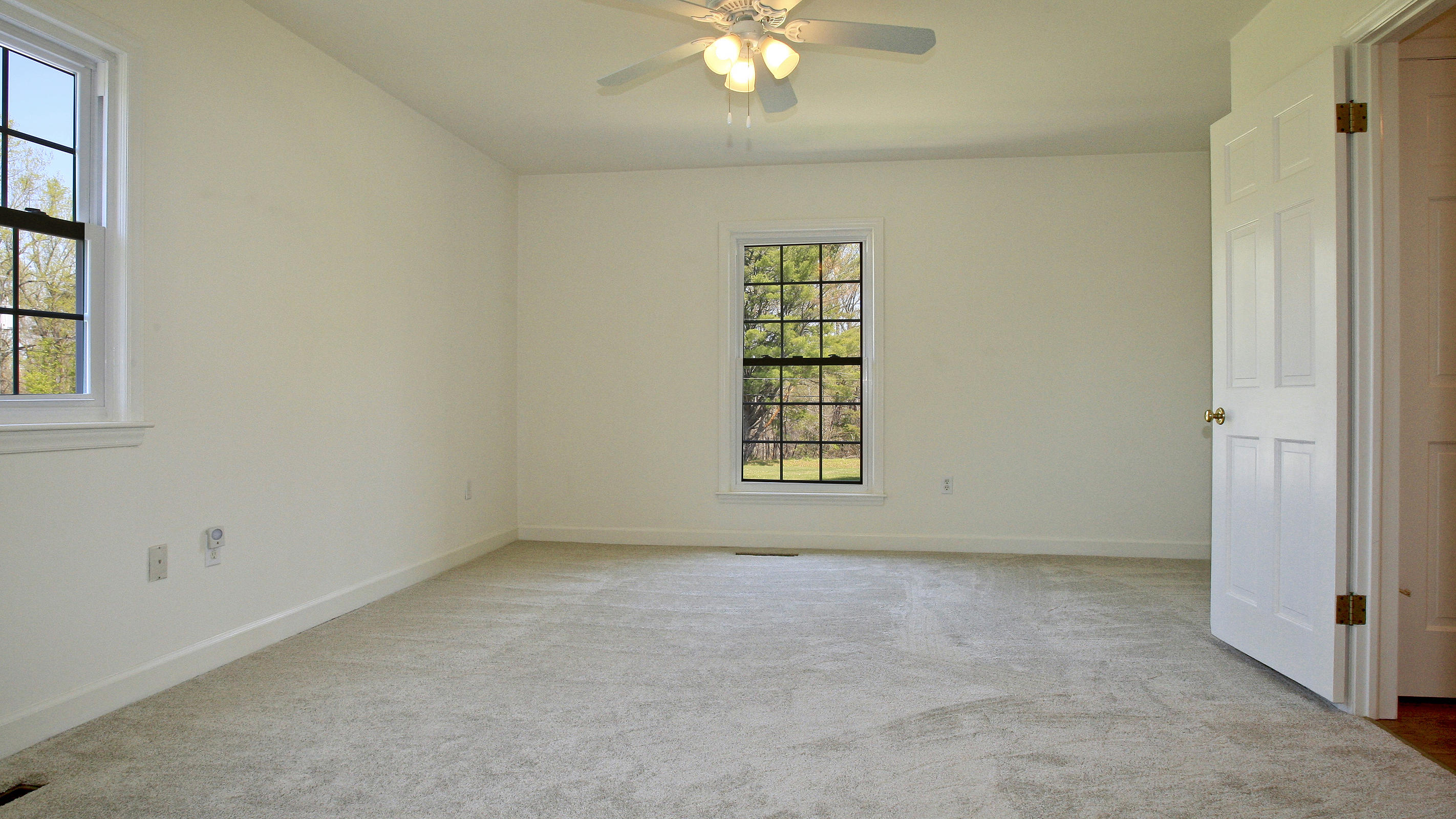 1229 Trails End Road Goodview, VA 24095 - Photo 51 of 106 an empty room with windows and chandelier fan