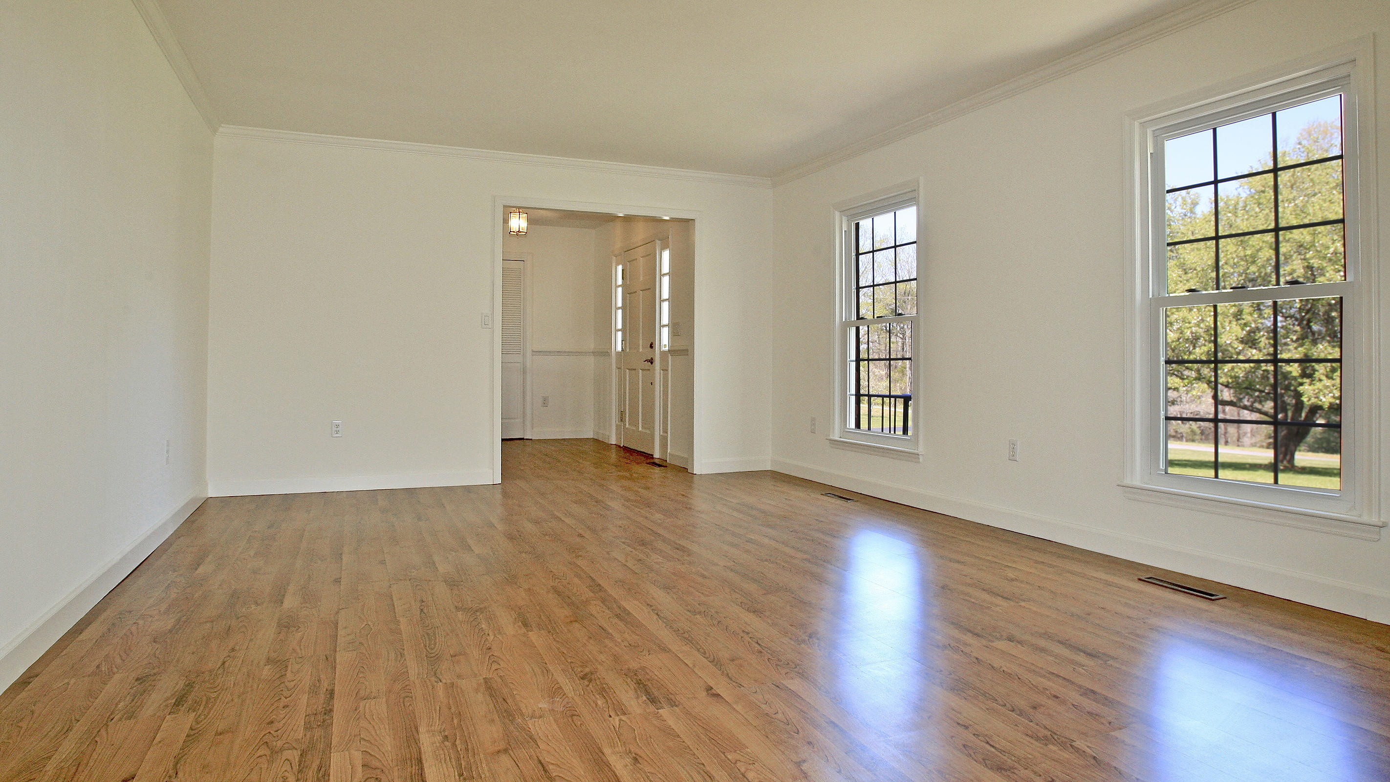 1229 Trails End Road Goodview, VA 24095 - Photo 65 of 106 a view of an empty room with wooden floor and windows
