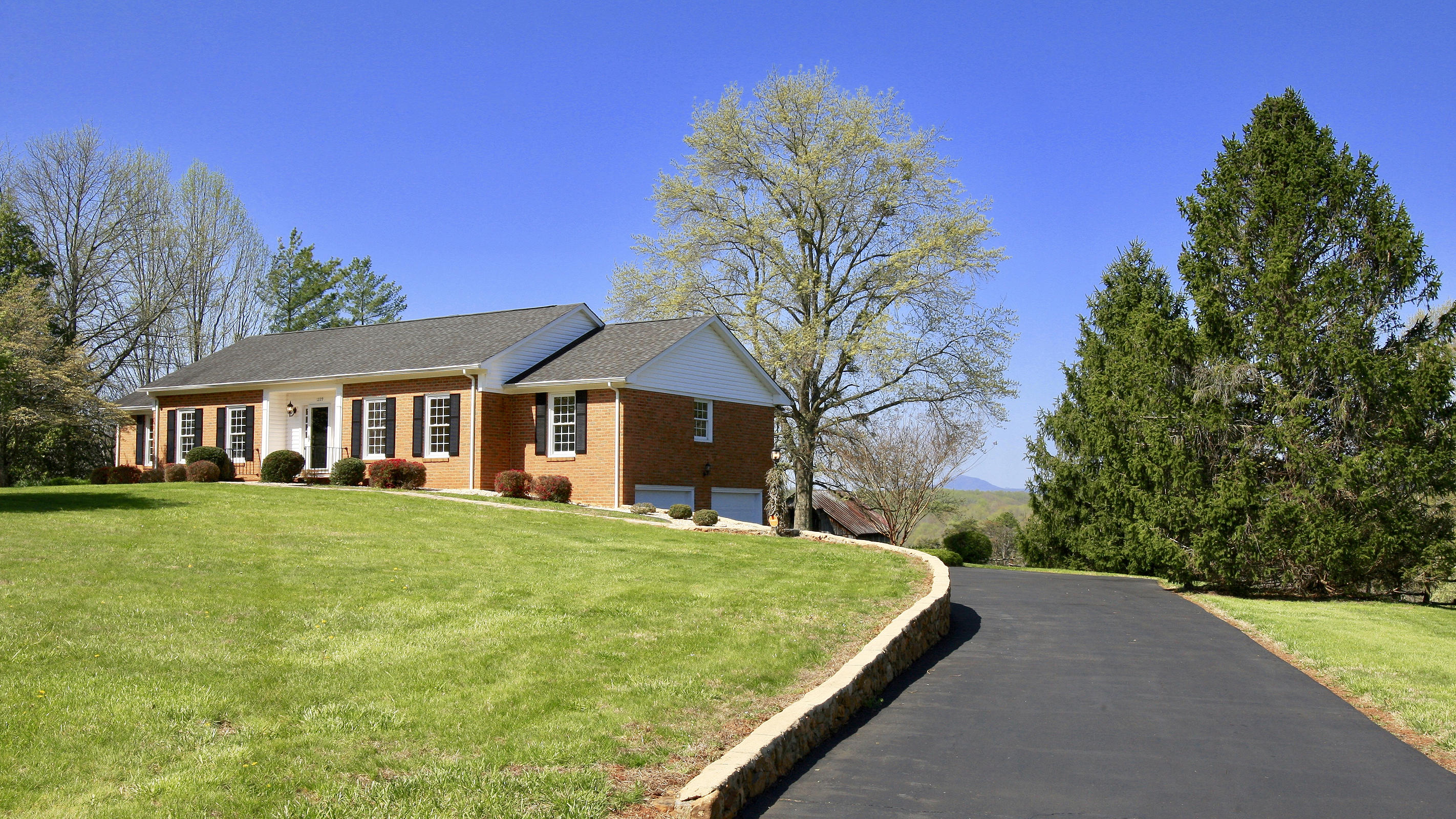 1229 Trails End Road Goodview, VA 24095 - Photo 9 of 106 a front view of a house with a yard and trees