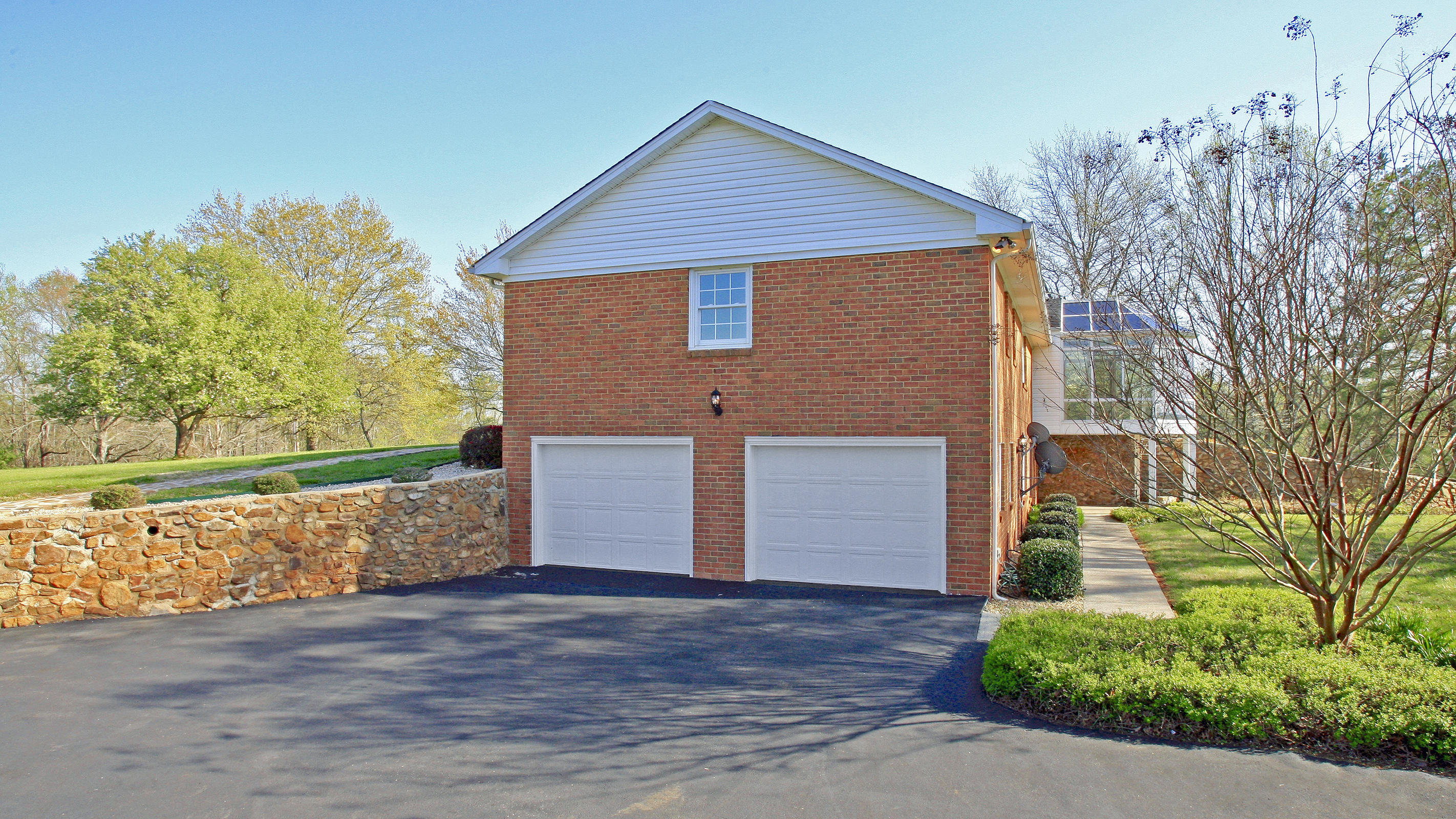 1229 Trails End Road Goodview, VA 24095 - Photo 92 of 106 a front view of a house with a yard and garage