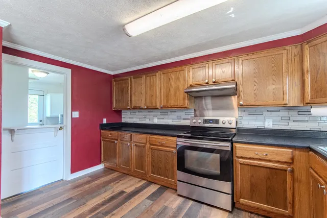 a kitchen with stainless steel appliances granite countertop a stove and a sink