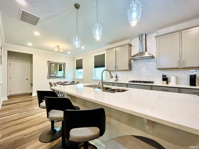 a large kitchen with lots of counter space a sink and cabinets