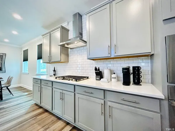 a kitchen with stainless steel appliances a sink stove and cabinets