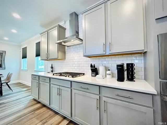 a kitchen with stainless steel appliances a sink stove and cabinets