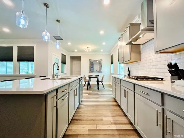 a kitchen with stainless steel appliances a sink stove and cabinets