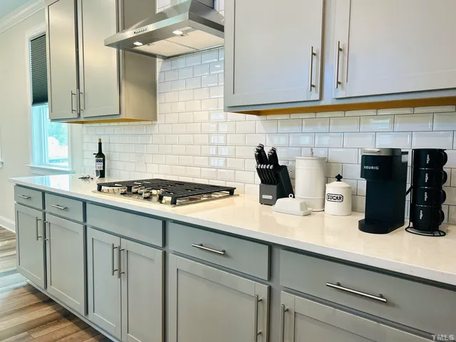 a kitchen with a sink and cabinets