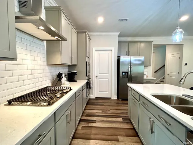a kitchen with a sink stove and refrigerator