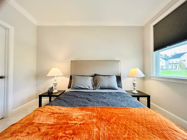 a bed room with a bed and a lamp