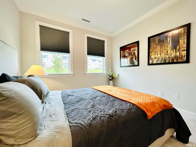 a bedroom with a bed and glass windows