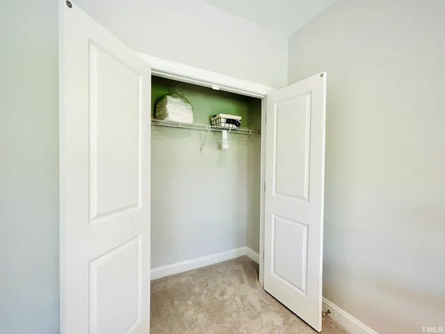 a bathroom with a sink a toilet a mirror and shower