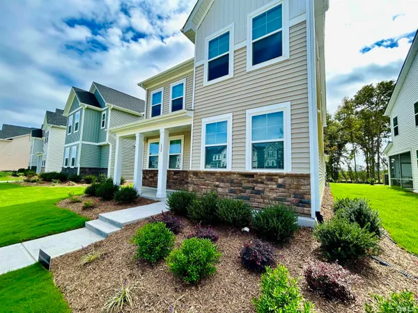 a front view of a house with garden