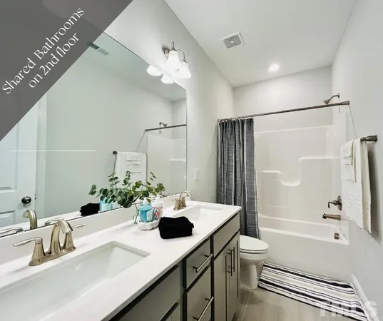 a bathroom with a bathtub shower sink vanity and toilet