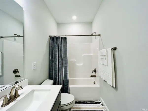 a bedroom with a bed and a night stand