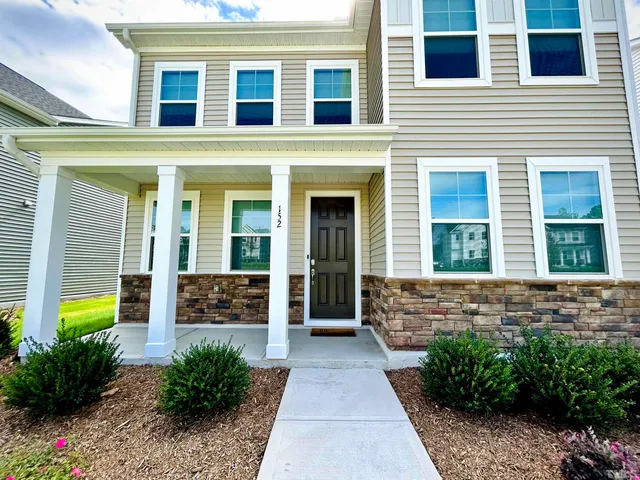 a view of a brick house with large windows