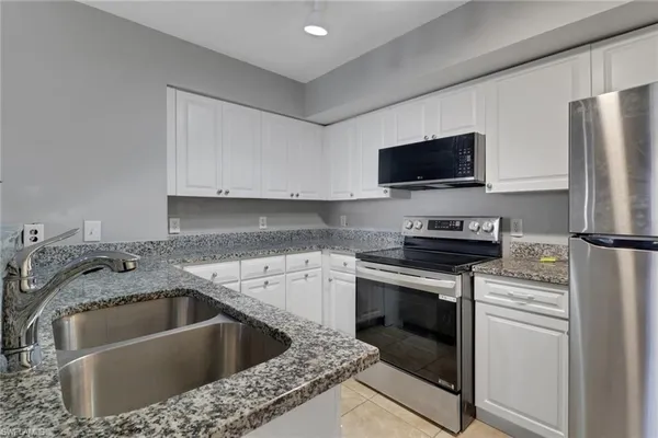 a kitchen with a sink stove and refrigerator