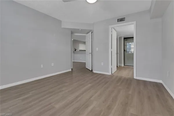 a view of an empty room and wooden floor