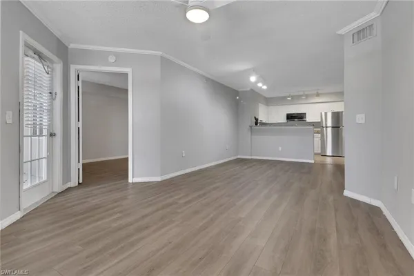 a view of a kitchen with a sink and a refrigerator