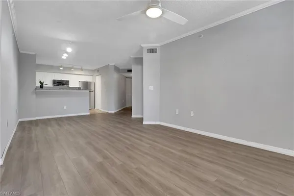 a view of a kitchen with a sink and a refrigerator