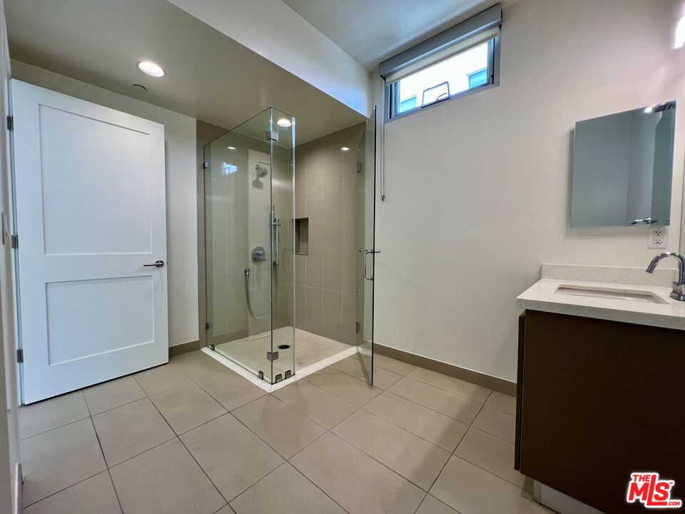 11715 Bellagio Road, Unit 204 Los Angeles, CA 90049 - Photo 12 of 27 a bathroom with a sink a toilet and shower