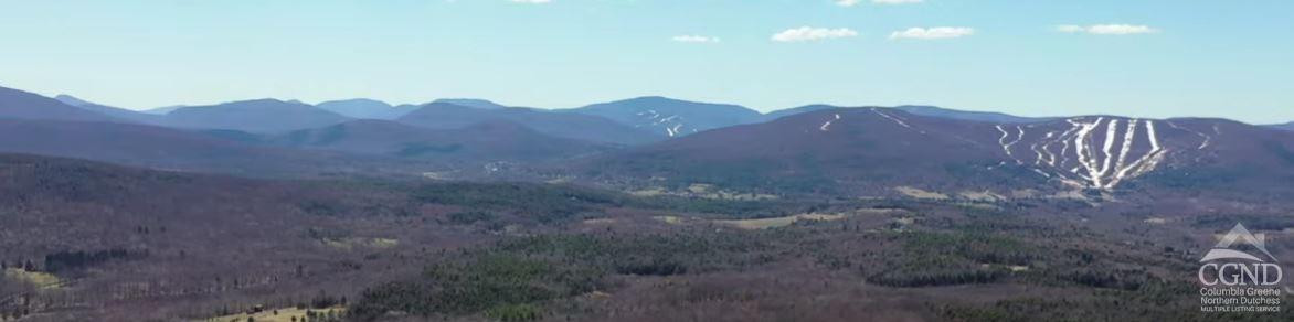 760 County Route 10 Windham, NY 12496 - Photo 1 of 27 a view of a large building with a mountain in the background