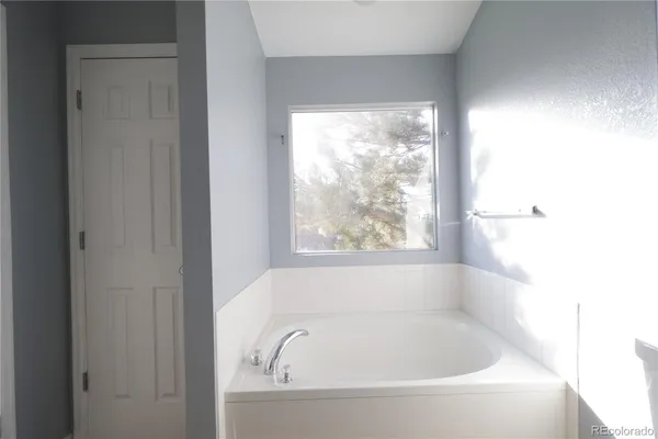 a white bath tub sitting next to a window