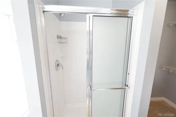 a bathroom with a glass shower door