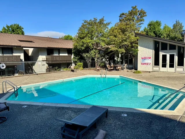 a backyard of a house with yard and outdoor seating