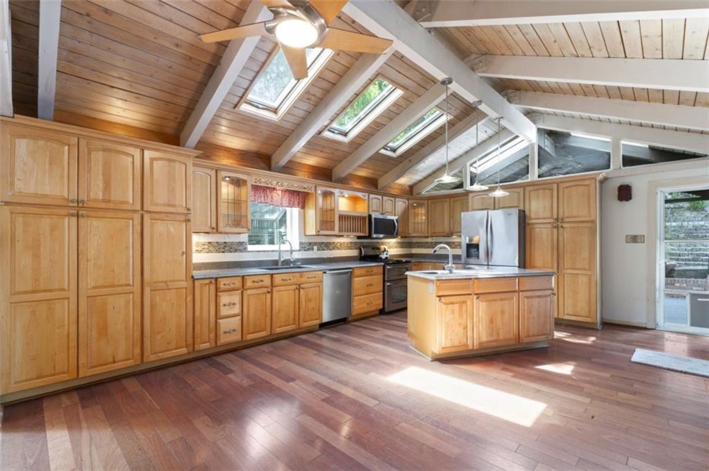 106 Sunset Street McKees Rocks, PA 15136 - Photo 11 of 45 a kitchen with sink cabinets and wooden floor