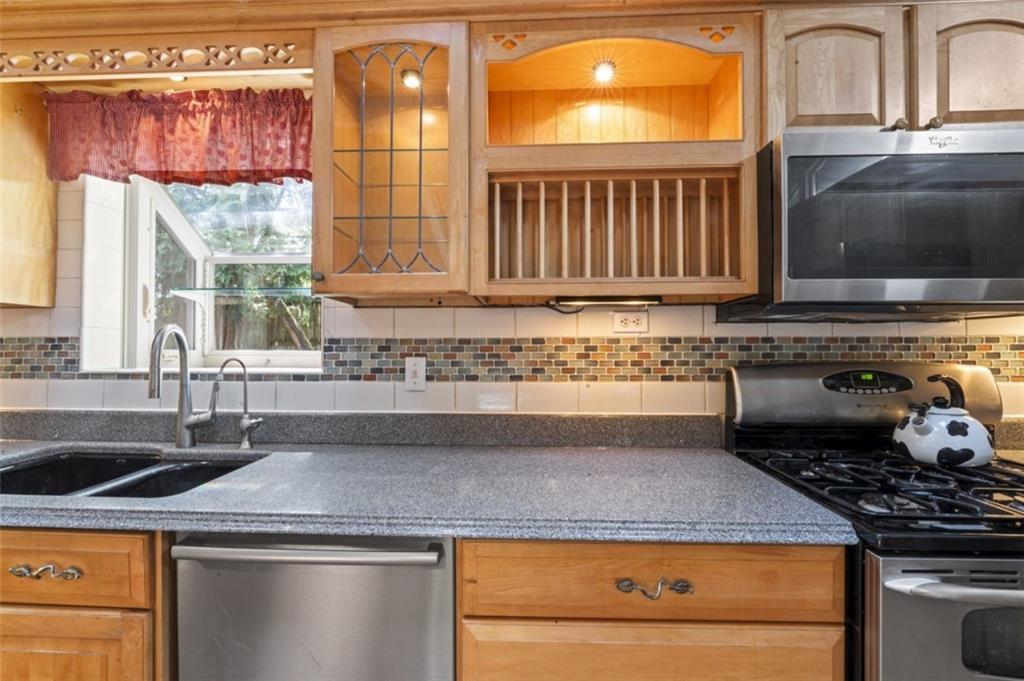 106 Sunset Street McKees Rocks, PA 15136 - Photo 13 of 45 a kitchen with granite countertop a sink and a stove
