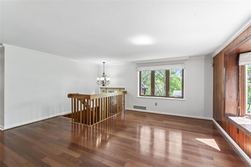 106 Sunset Street McKees Rocks, PA 15136 - Photo 9 of 45 an empty room with wooden floor and windows