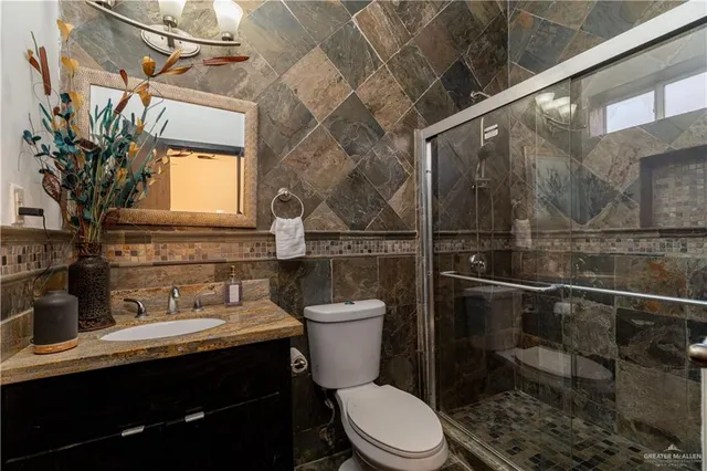 a bathroom with a toilet a sink and mirror