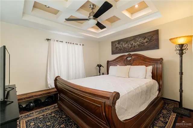 a bedroom with a bed and a chandelier