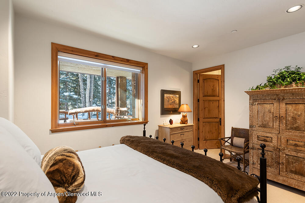 165 Miners Trail Road Aspen, CO 81611 - Photo 14 of 23 a bedroom with a bed and wooden floor
