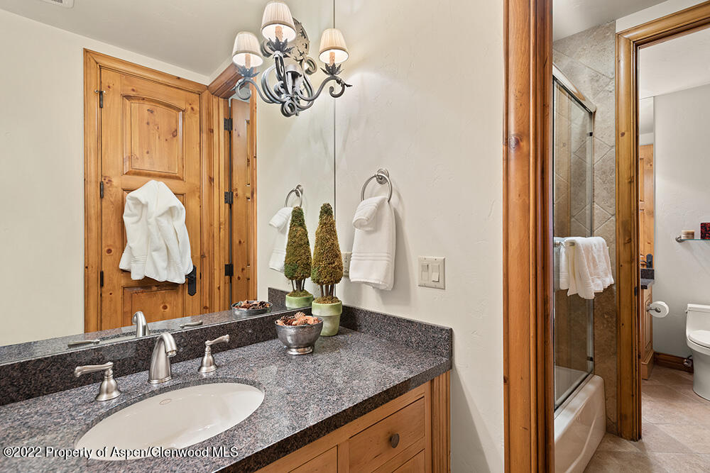 165 Miners Trail Road Aspen, CO 81611 - Photo 17 of 23 a bathroom with a granite countertop sink a mirror and a shower