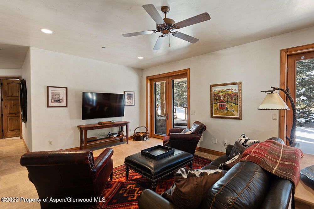 165 Miners Trail Road Aspen, CO 81611 - Photo 20 of 23 a living room with furniture and a flat screen tv