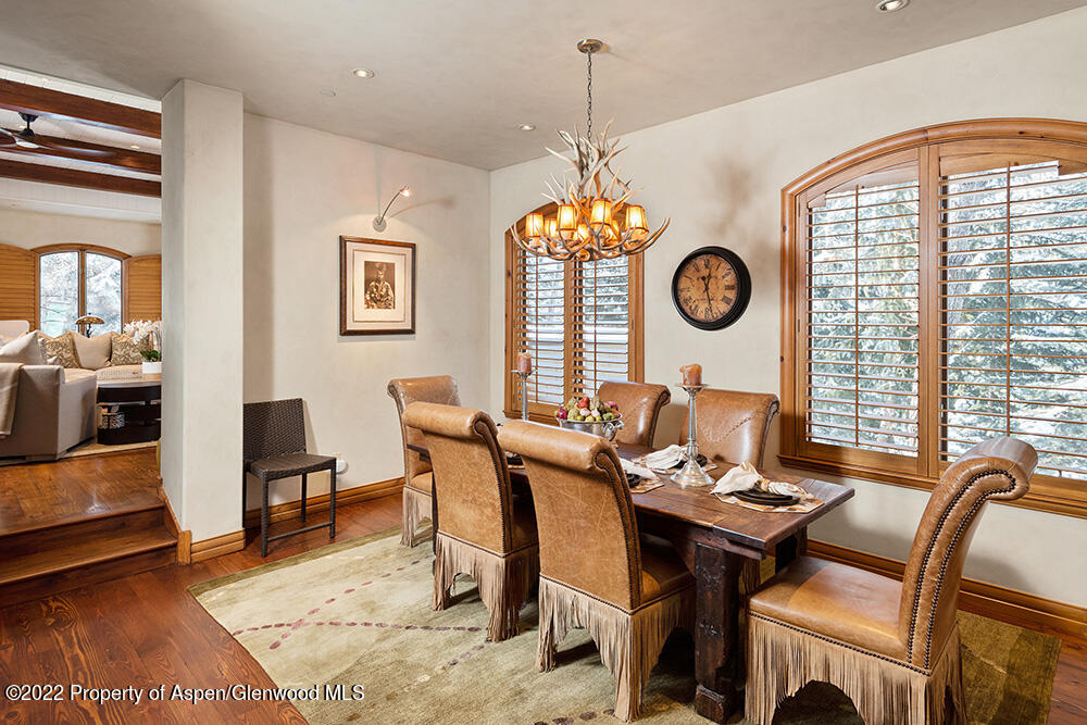 165 Miners Trail Road Aspen, CO 81611 - Photo 4 of 23 a view of a dining room and livingroom with furniture wooden floor and a rug