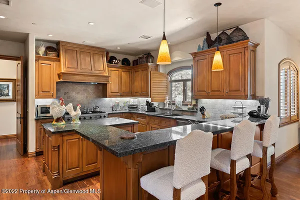 a kitchen with a sink a counter space appliances and cabinets