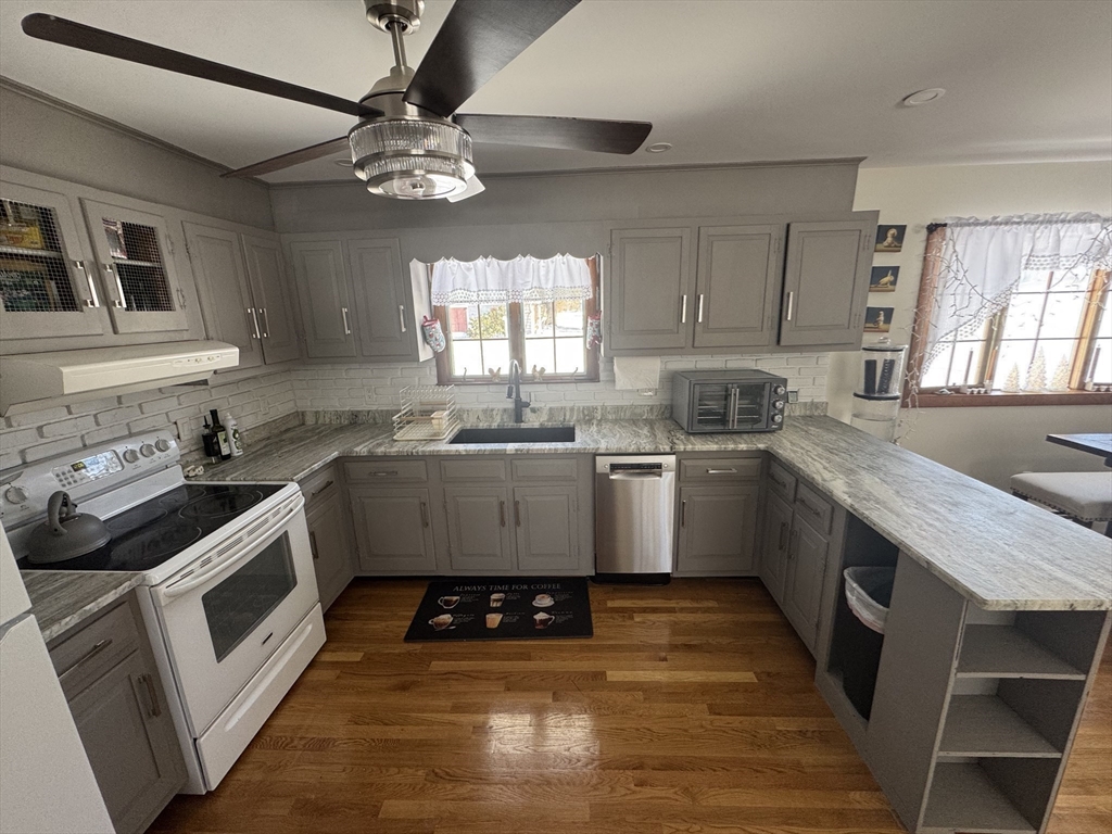 2 Blacksnake Road Salisbury, MA 01952 - Photo 11 of 31 a kitchen with a stove sink and cabinets