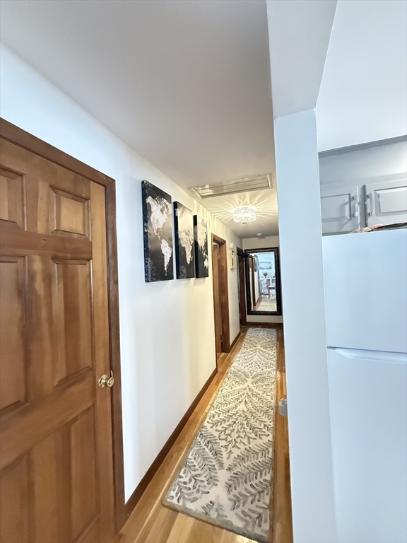 2 Blacksnake Road Salisbury, MA 01952 - Photo 12 of 31 a view of a hallway with wooden floor and a living room