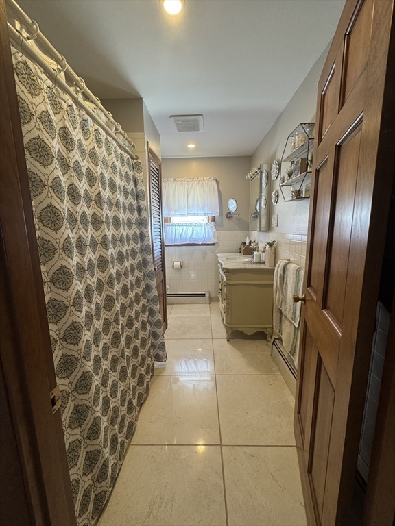2 Blacksnake Road Salisbury, MA 01952 - Photo 13 of 31 a bathroom with a sink and mirror with bathtub