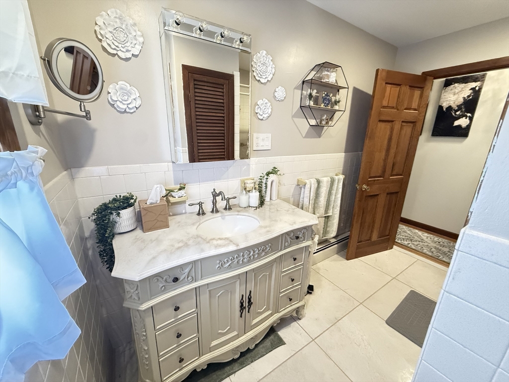 2 Blacksnake Road Salisbury, MA 01952 - Photo 15 of 31 a bathroom with a granite countertop sink and a mirror