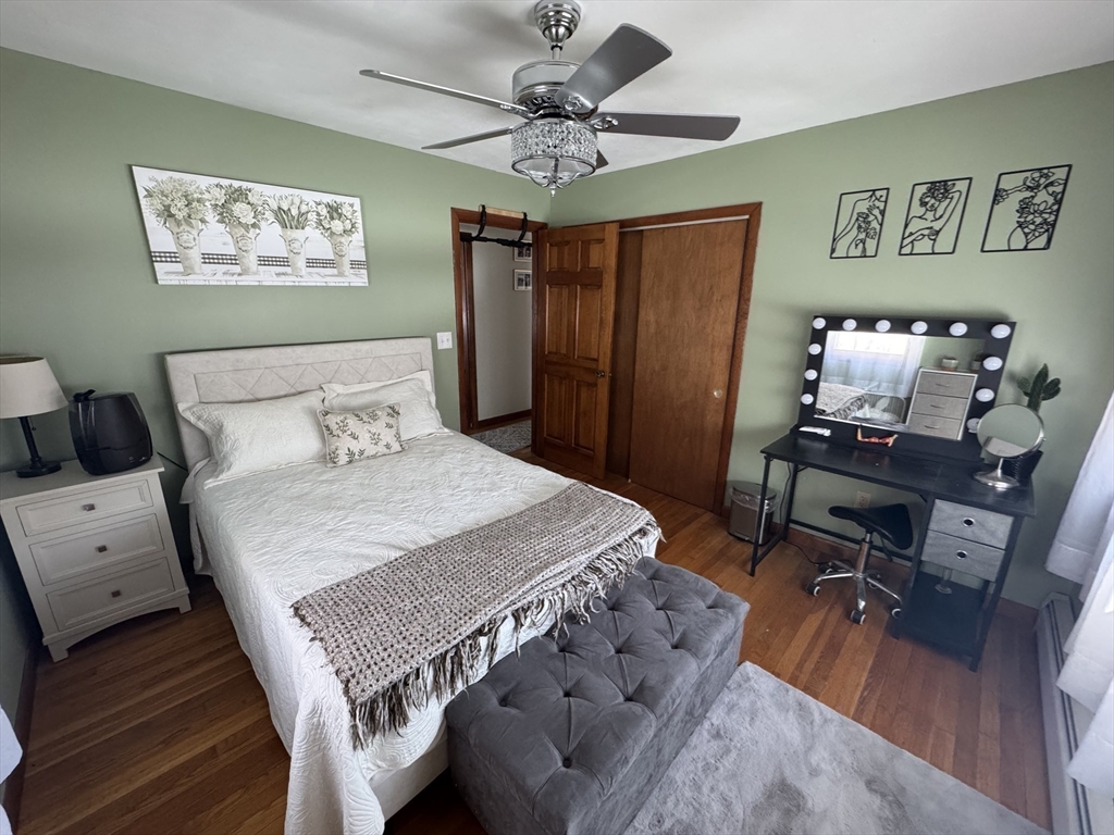 2 Blacksnake Road Salisbury, MA 01952 - Photo 18 of 31 a bedroom with a bed and a chandelier