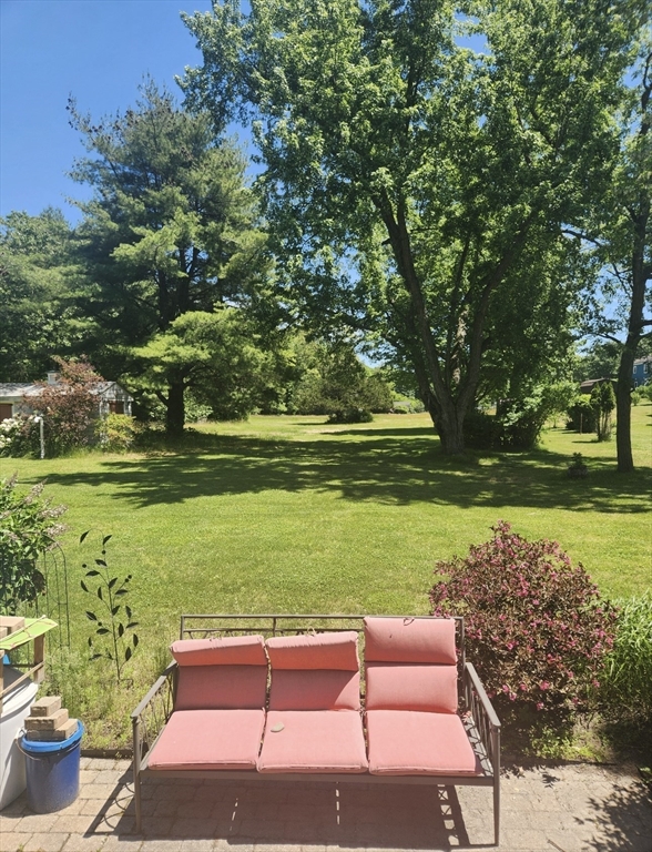 2 Blacksnake Road Salisbury, MA 01952 - Photo 2 of 31 a yard with table and a chairs under an umbrella