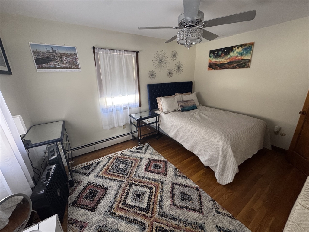 2 Blacksnake Road Salisbury, MA 01952 - Photo 23 of 31 a bedroom with a bed and a lamp on dresser