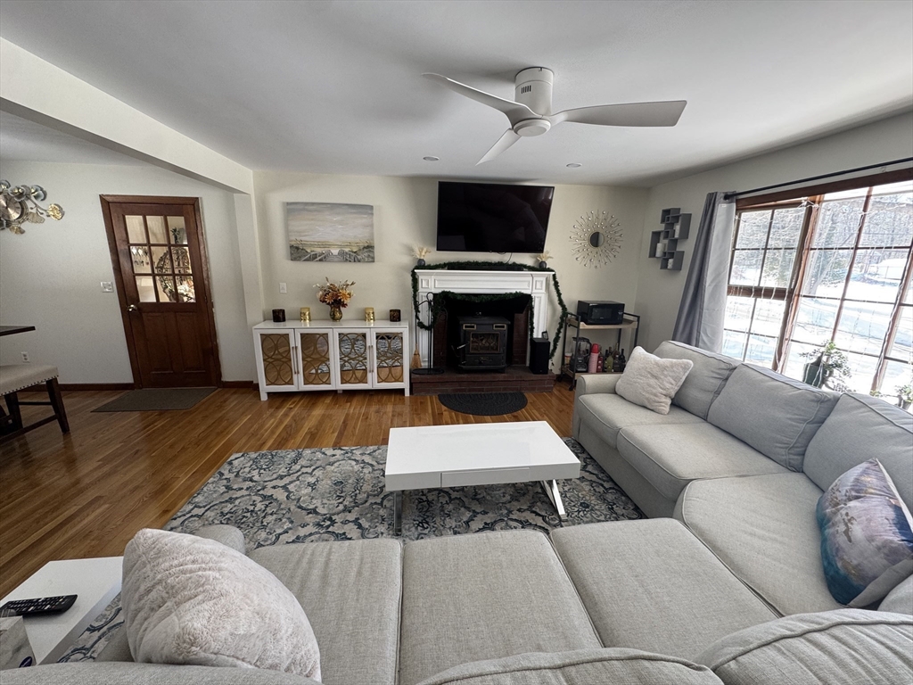 2 Blacksnake Road Salisbury, MA 01952 - Photo 4 of 31 a living room with furniture a flat screen tv and a fireplace