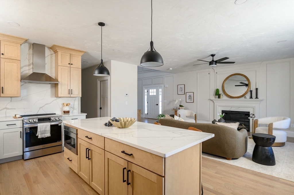 78 Metacomet Road, Unit 78 West Bridgewater, MA 02379 - Photo 16 of 39 a kitchen with a stove kitchen island and a refrigerator