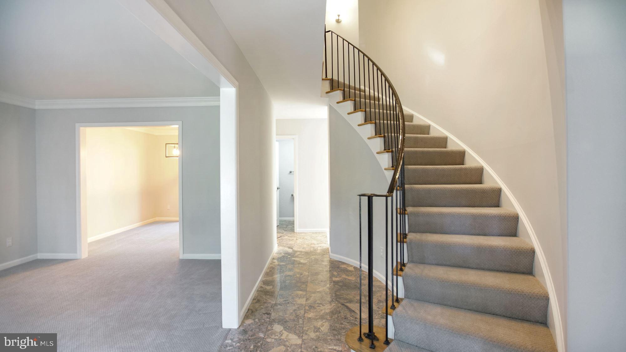 6002 Waterbury Court Springfield, VA 22152 - Photo 4 of 31 Marble floor foyer and elegant curved staircase