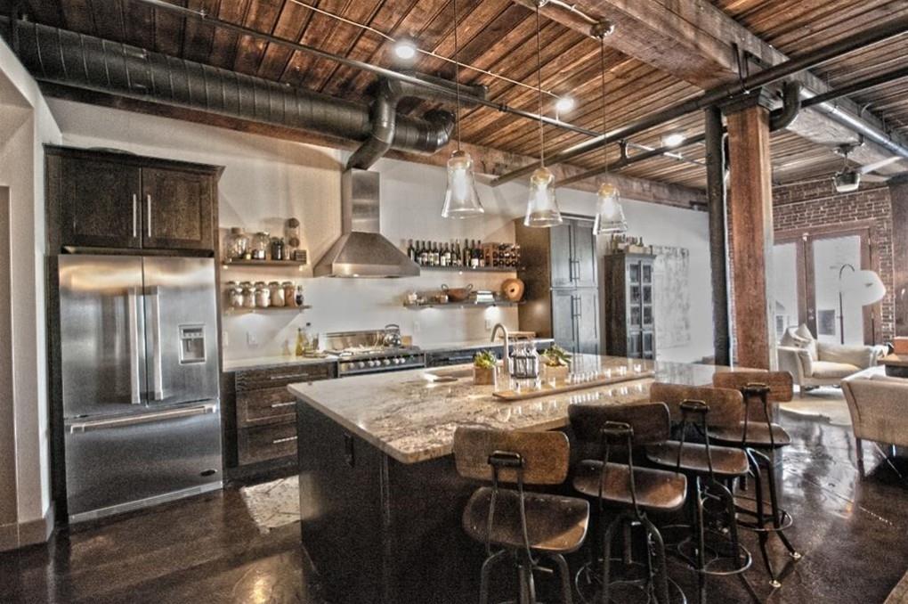 a kitchen with refrigerator and chairs