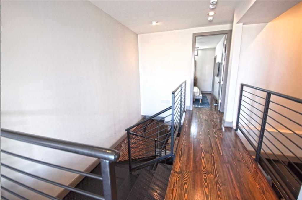 320 Peters Street Southwest, Unit 10 Atlanta, GA 30313 - Photo 13 of 20 a view of a hallway with wooden floor and staircase