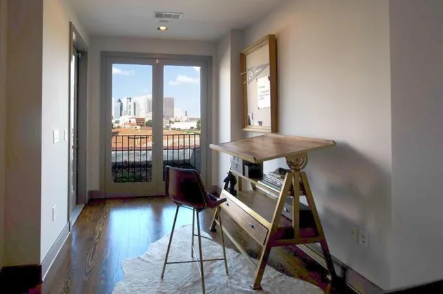 a view of a balcony with chairs and front door
